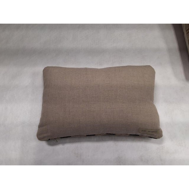 Pat McGann throw pillow made with handwoven textile fabric from Neeru Kumar in Ocean Stripe Charcoal. Fabric materials are...