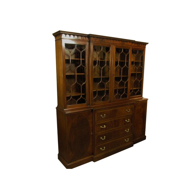 A Georgian style inlaid mahogany breakfront by H Sacks and Sons. Features dovetail drawer construction, rosewood banding...