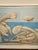 The image shows a framed art print of Pablo Picasso's 1937 work La Baignade (On the Beach). ® • Artist: Pablo Picasso •...