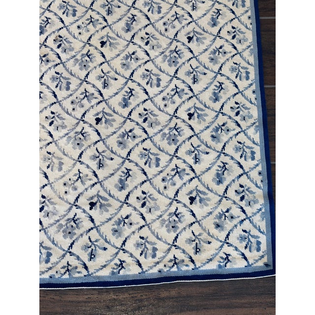 Beautiful needlepoint hand crafted textile featuring a blue floral design on a cream background with a light blue and navy...