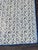 Beautiful needlepoint hand crafted textile featuring a blue floral design on a cream background with a light blue and navy...