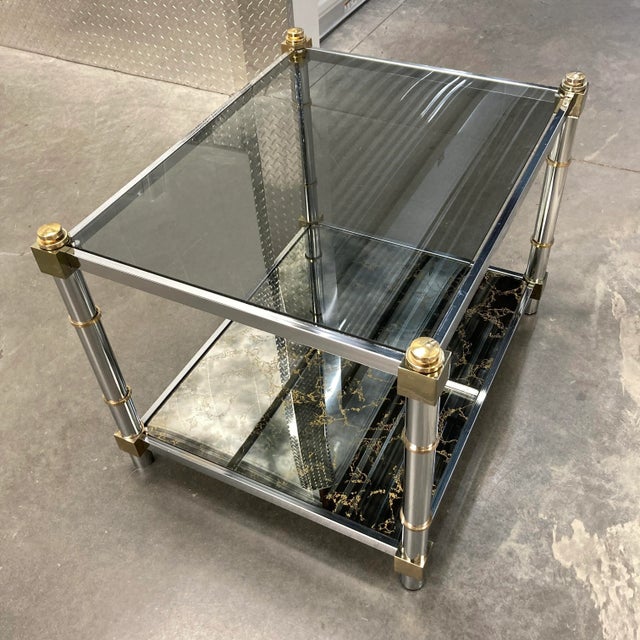 French Jansen design tiered end table in chrome, brass, smoked glass, and acid drip bronze mirrored lower, mirror back...