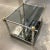 French Jansen design tiered end table in chrome, brass, smoked glass, and acid drip bronze mirrored lower, mirror back...