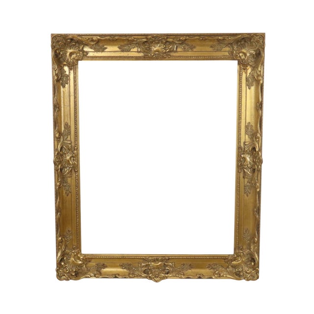 Large gold-colored vintage pine frame with a very beautiful aged patina, entirely in classic Baroque style, decorated with...