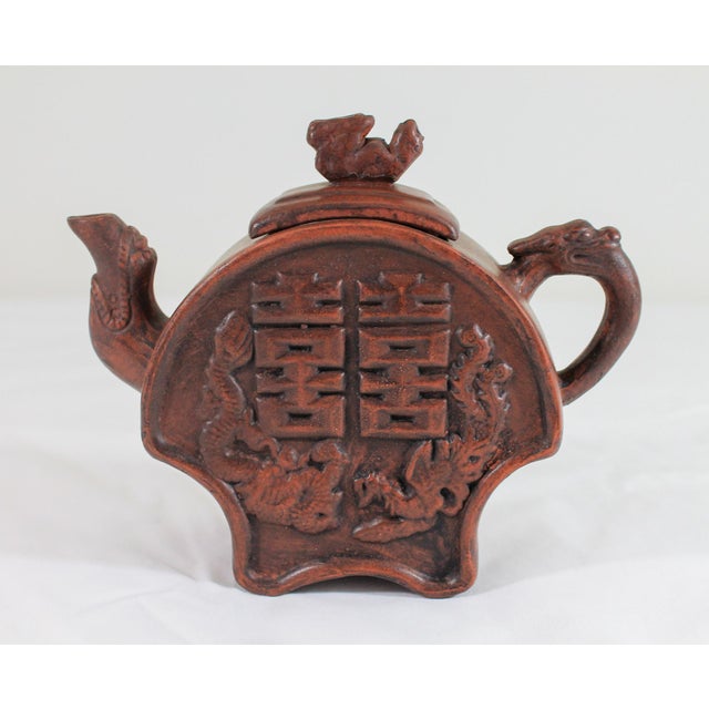 Vintage brown Chinese clay tea pot with bird and dragon motif. Makers stamp inside lid and on the bottom. One very small...