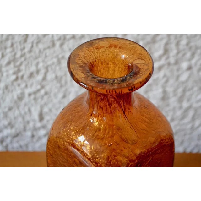 This piece is originally from Denmark. It is a vase made of blown glass. It was beautiful crafted, showing imperfections...