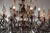 A most charming italian 19th century pressed patinated metal, giltwood and crystal twelve lights genovese chandelier. This...