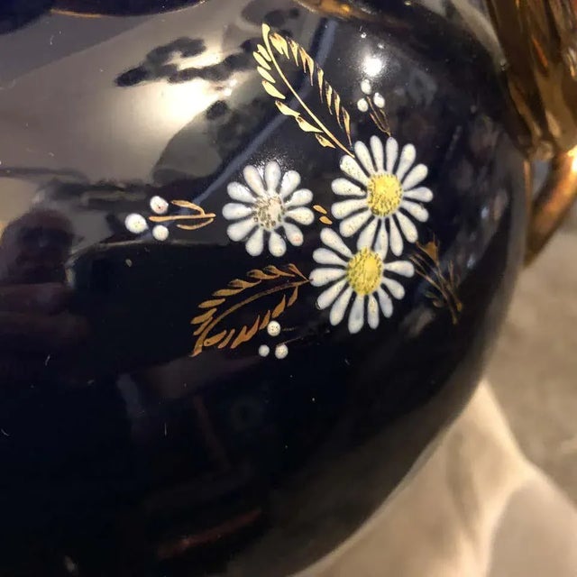 A blue and gold ceramic vase decorated with flowers made in Italy in the 1960s by Saca. Excellent conditions. Marked on...