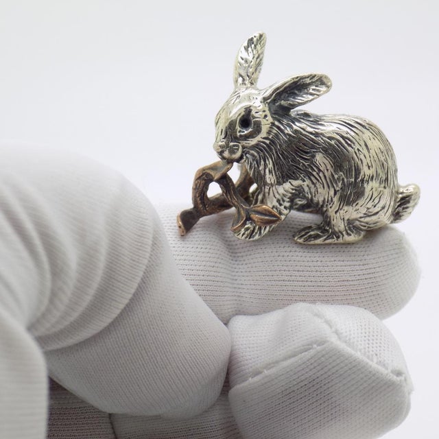 Vintage miniature sculpture with a sweet, naturalistic charm, depicting a little rabbit holding a twig, handcrafted in...