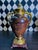 A pair of large metal decorative urns combining classical form with an unusually rich, mottled brown finish and...