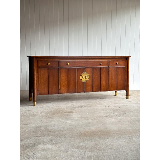 This vintage Hollywood Regency Chinoiserie-style credenza buffet cabinet showcases a long, architectural silhouette with...