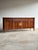 This vintage Hollywood Regency Chinoiserie-style credenza buffet cabinet showcases a long, architectural silhouette with...