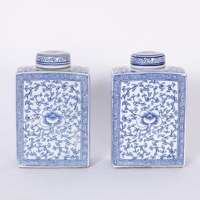 Delightful pair of Chinese blue and white porcelain lidded ginger jars hand decorated with lotus leaves and flowers.
