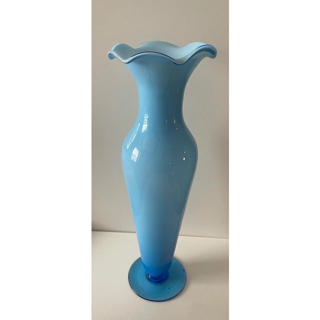 Stunning 17” tall empoli vase in light blue cased glass makes an impact in any room. Footed you can see the royal blue...