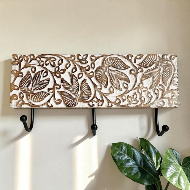 Enhance your home decor with the White Washed Carved Mango Wood 3 Hook Wall Rack, a perfect blend of functionality and...