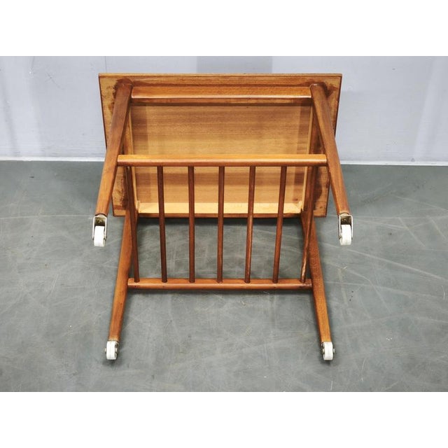Elegant danish modern teak serving trolley or side table, made in denmark during the 1960s. The piece features a...