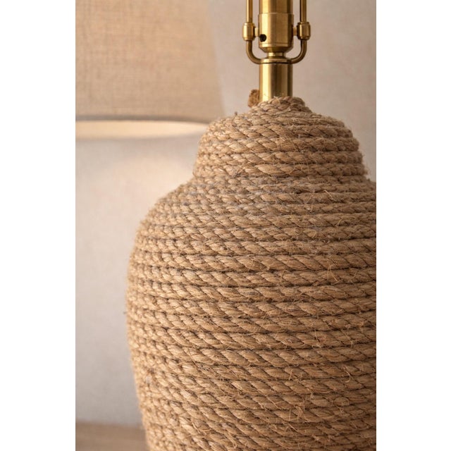 A beautifully textured rope-wrapped table lamp that brings warmth and natural character to any space. The sculptural,...