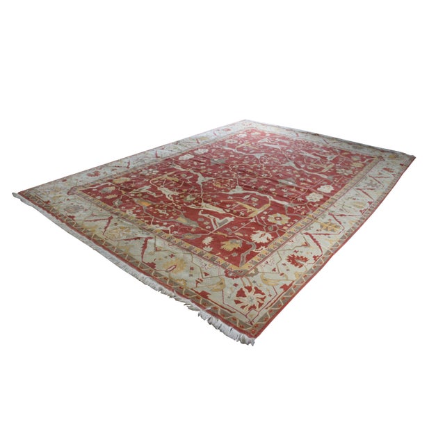 A massive late 20th century Turkish Oushak area rug. Hand made from 100% wool with beige and red pile and geometric...