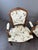 An elegant set comprising two armchairs and two matching footstools, crafted from finely carved wood. Louis XV style, late...