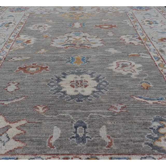 Modern Floral Designed Oushak With Muted Background With Earthy Tones and Soft Blue For Sale - Image 3 of 13