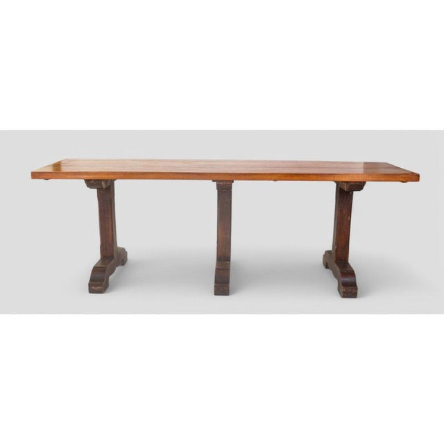 Solid, austere, and steeped in history, this early 20th-century refectory table is a genuine piece of rustic, monastic-...