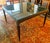 The Vintage Mattaliano Large Casino Game Table features a dark wood base with a glass top, measuring 48" square. This...