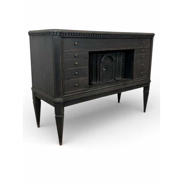 A truly unique Swedish chest of drawers with numerous drawers in a deep black finish. A toothed strip sits beneath the...