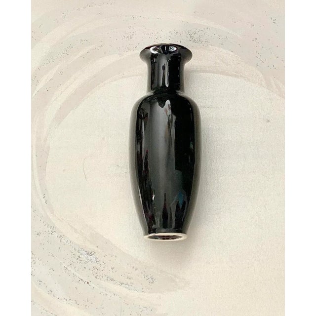 What a beautiful classic Japanese vase! Black porcelain vase decorated with intricate gilt design of two peacocks and...