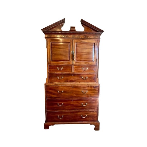 Early 19th Century American linen press butler's cabinet and desk crafted of mahogany and Chippendale-style. The top...