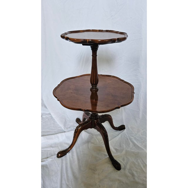 Beautiful Antique/Vintage 2-Tier Table. The style is traditional Chippendale. The use of these tables has been known by...