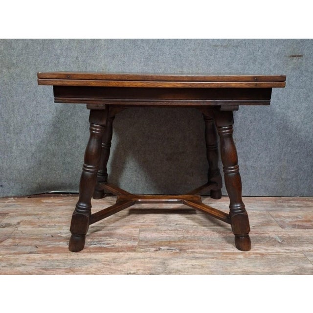 Extendable renaissance-style table in solid oak, circa 1950-1960. this charming rectangular tabletop features an elegant...