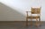 This oak armchair, executed in the unmistakable style of Henning Kjærnulf, commands attention with its bold brutalist...