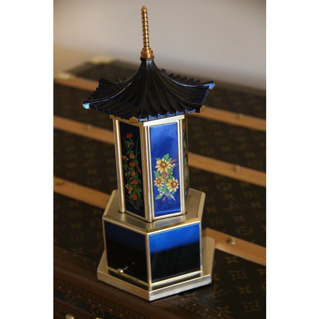 This mid-century vintage cigar carousel with a music box is absolutely incredible. It features a sapphire blue lacquered...