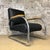 Easy Chair, from a Flemish designer in Black leathered with natural wooden armrests. The Armchair show some signs of use...