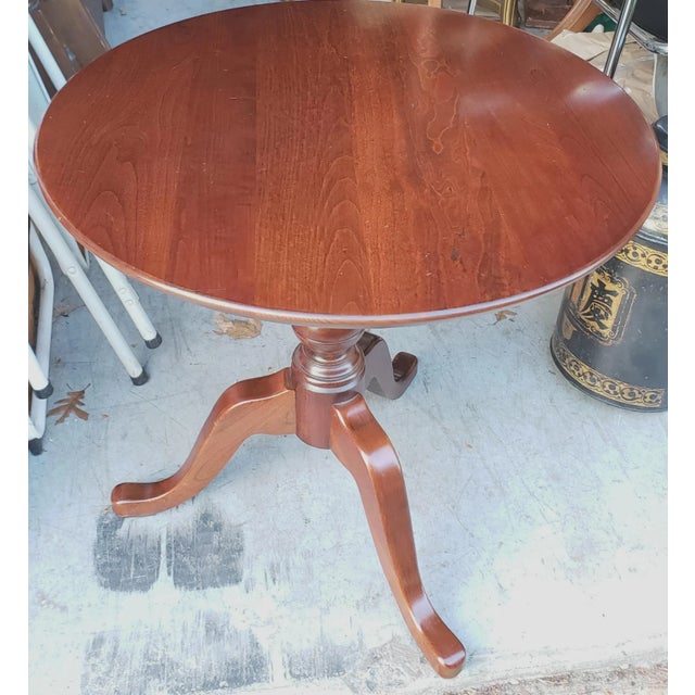 A beautiful Pennsylvania House Solid Cherry Tilt-Top Round Center Table. 25" in diameter. 39" in height with top tilted.