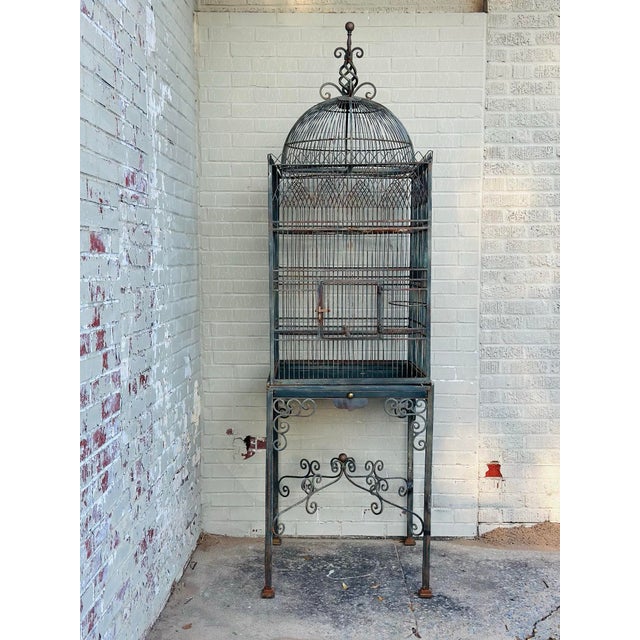 This vintage Maitland-Smith birdcage is a striking decorative piece that blends classical elegance with sculptural...