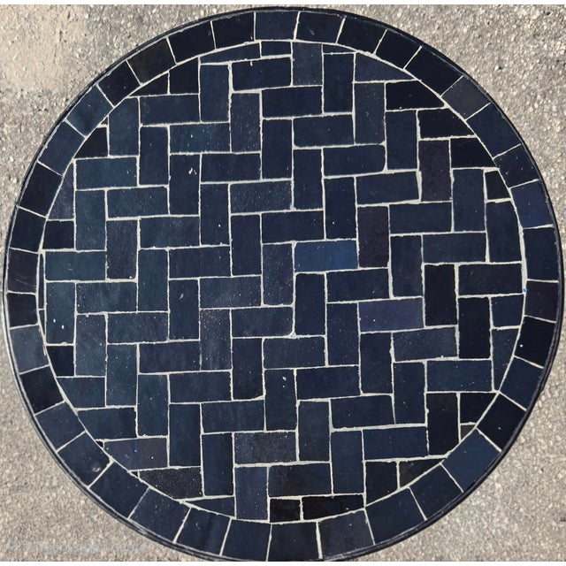 Bring timeless style to your home or patio with this charming mini mosaic accent table. Featuring a black mosaic tile top...