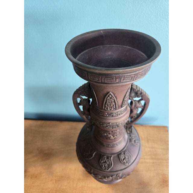 This stunning set of antique bronze includes a patinated bronze vase adorned with embossed floral design and a mythical...