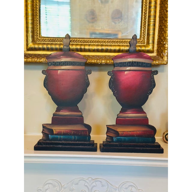 These are a striking pair of hand-painted wooden decorative urns, crafted as dimensional trompe l’oeil sculptures that...