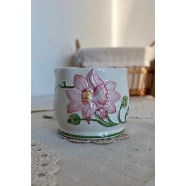 Bring a touch of charm and elegance to your interior with this pretty vintage earthenware planter. Its delicate design is...