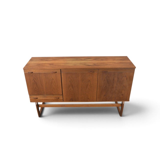 This credenza was made by Nathan Furniture in England during the 1960s. The teak case offers a compact width with clean...