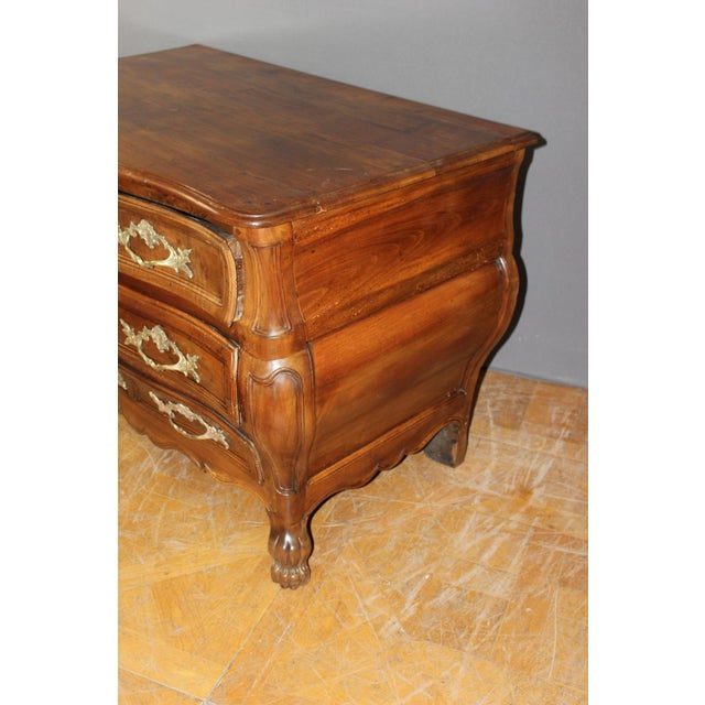 A Bordeaux-style walnut commode, curved and molded on three sides, with three drawers, solid walnut top, waxed finish,...