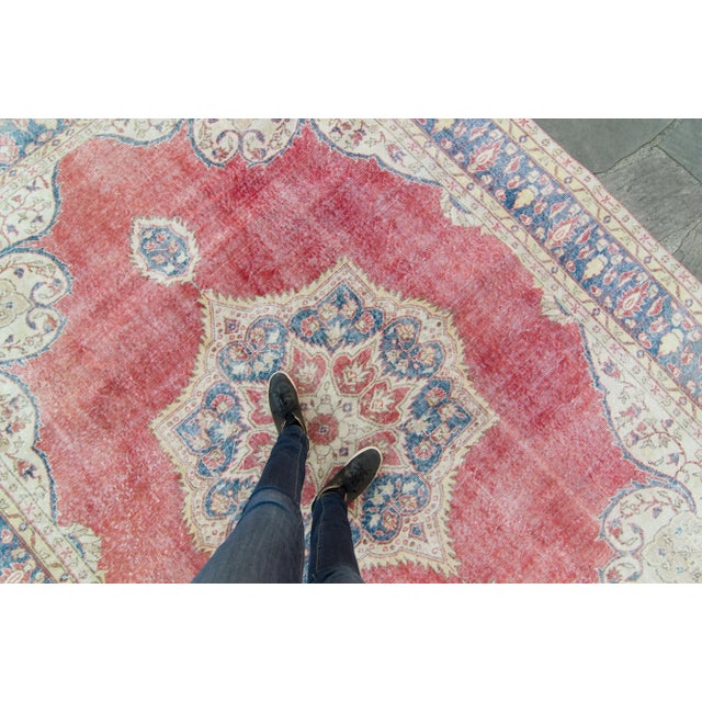 A lush area rug is decked out with a grand medallion for its centerpiece! Featuring colors such as reddish-pink for the...