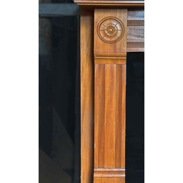 Antique late 19th century maple mantel having reeded jambs and frieze, and substantial corner blocks with rosette motifs....