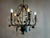 A large-scale vintage chandelier from the 1990s, crafted with a wrought iron body and adorned with delicate ivy and leaf...