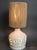Vintage ceramic table lamp attributed to Georges Pelletier (circa 1970s). A slightly chalky-white rounded form with a...