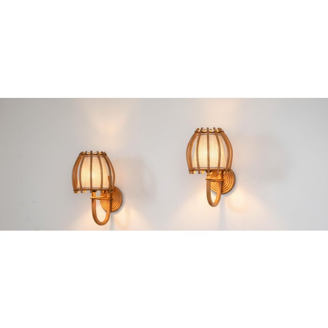 Elevate your space with this exquisite pair of handcrafted rattan wall lamps, where artisanal craftsmanship meets warm,...