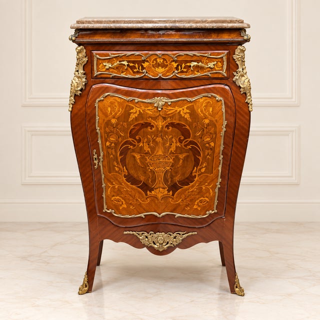 Elegant Louis XVI style commode cabinet featuring a refined beige marble top and exquisite marquetry craftsmanship with...
