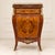 Elegant Louis XVI style commode cabinet featuring a refined beige marble top and exquisite marquetry craftsmanship with...