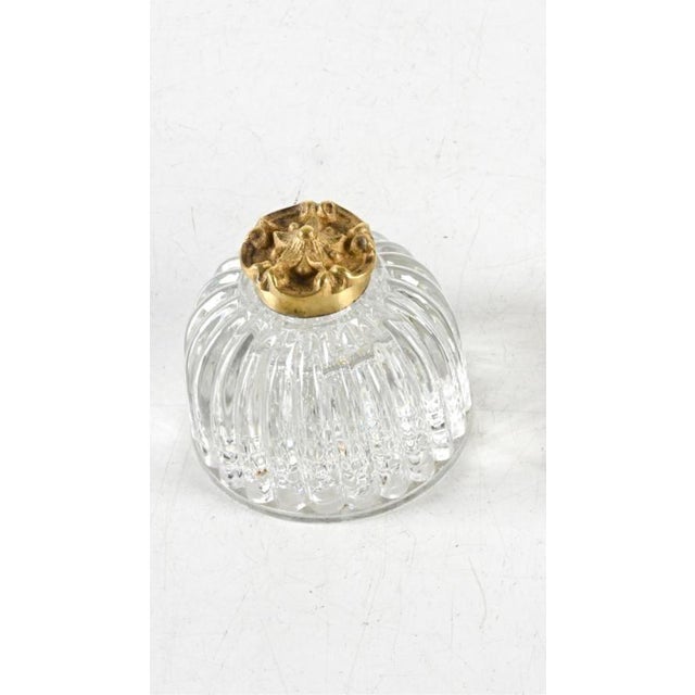 A 19th century small dome-shaped crystal inkwell in clear molded glass with vertical ribbing that scallops at the base,...